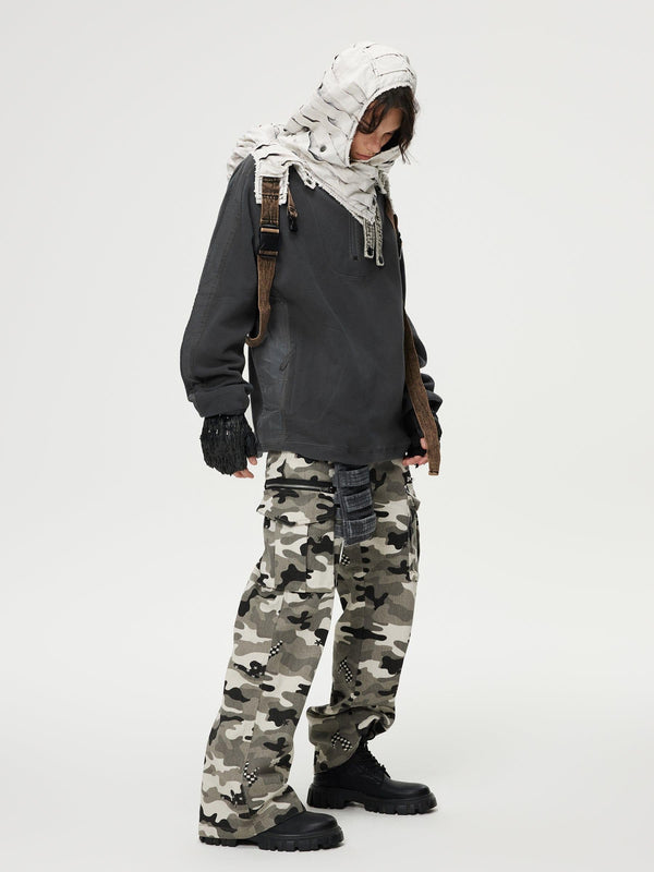 Model wearing camouflage multi-pocket jeans with a dark top and scarf by TALISHKO.