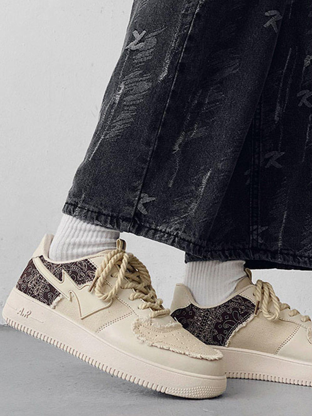 Front view of TALISHKO beige canvas shoes with intricate patchwork and textured details.