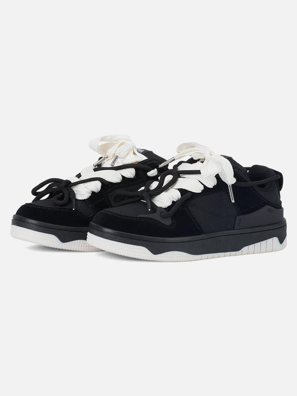 TALISHKO black sports shoes with contrasting white laces, perfect for a casual street look.