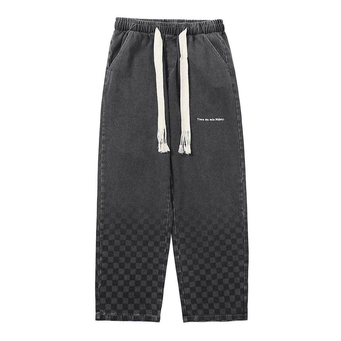 Front view of TALISHKO black checkerboard print jeans with drawstring waist and relaxed fit.