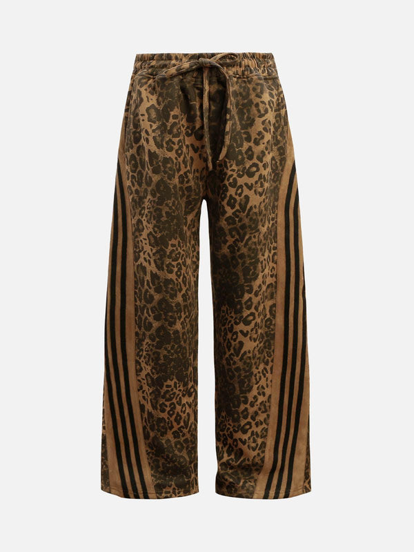 Front view of brown cheetah print suede pants by TALISHKO, featuring a drawstring waist.