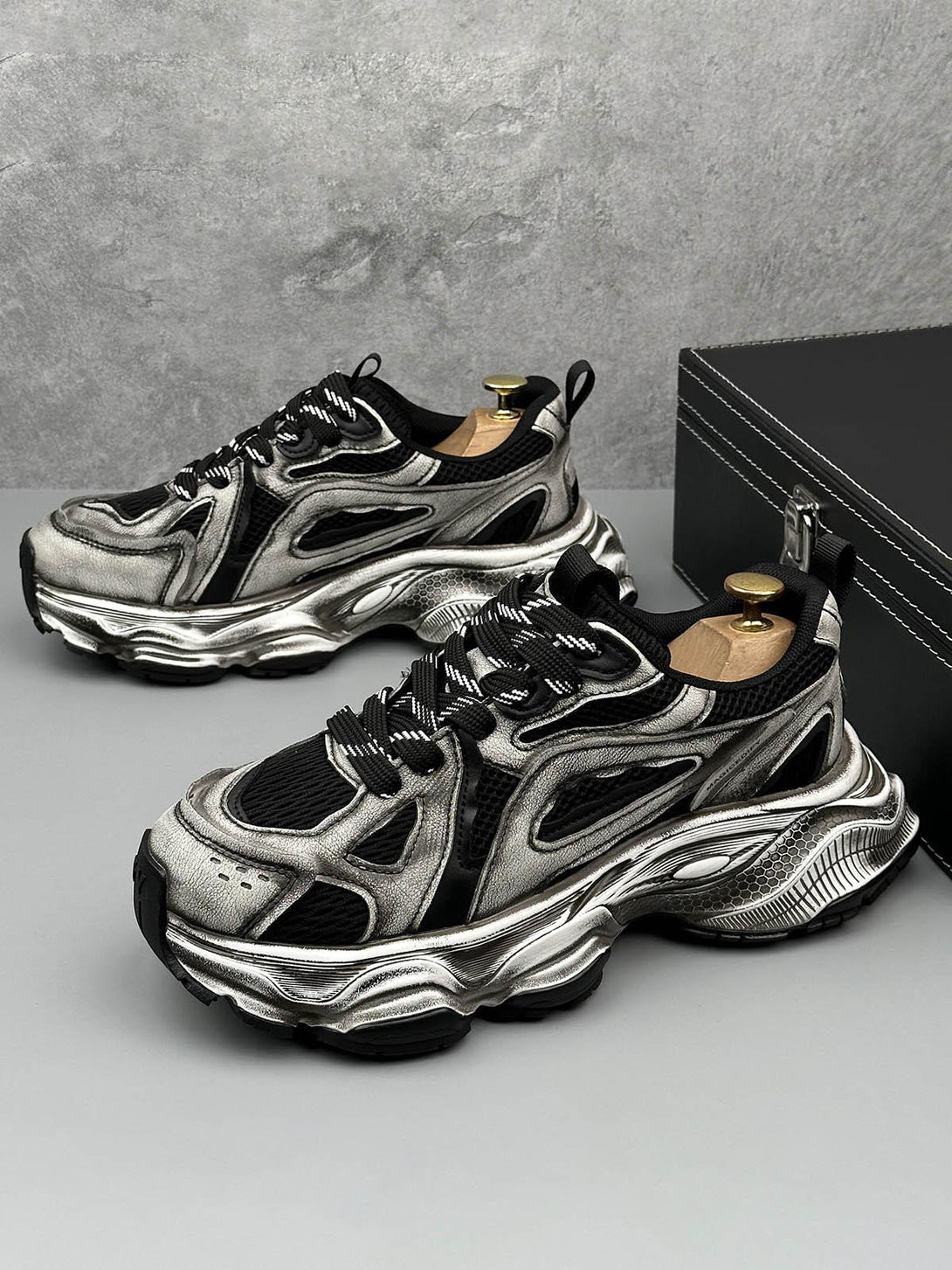 Front view of black chunky sole running sneakers by TALISHKO, showcasing a sleek design.