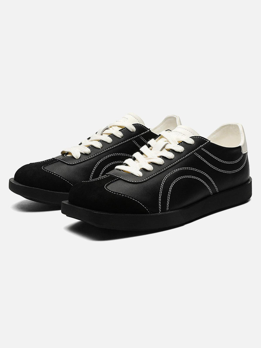 TALISHKO black leather sneakers with fluid lines, featuring a stylish front view.