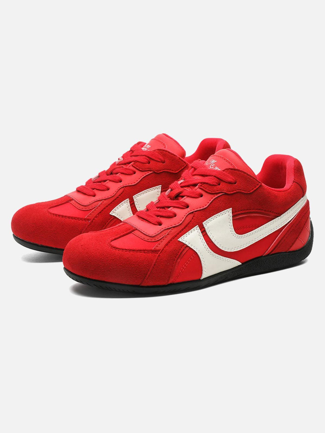 Red low-top sneakers by TALISHKO with suede texture and white accents, shown from the front.