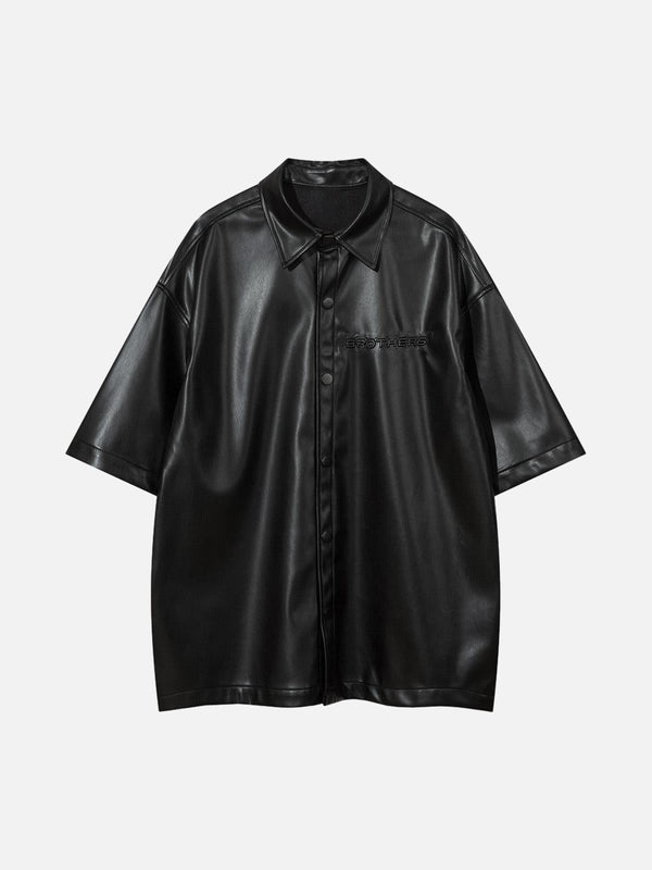 Front view of a black PU leather shirt by TALISHKO, featuring short sleeves and bold street style.
