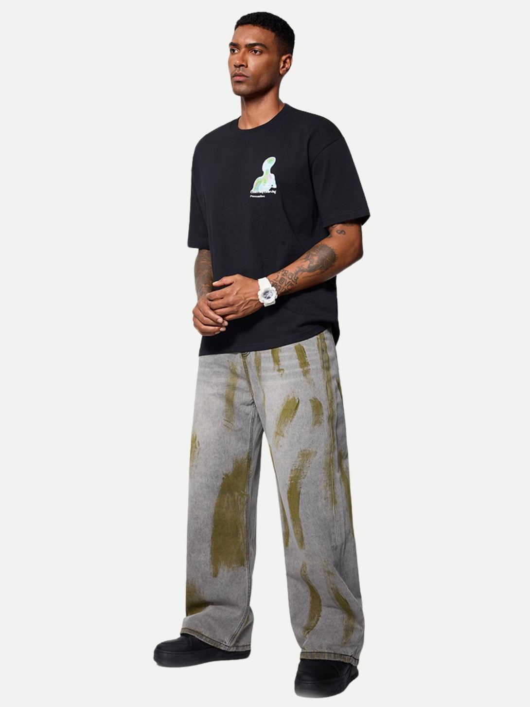 Model wearing gray color blocking loose jeans by TALISHKO, highlighting street style.