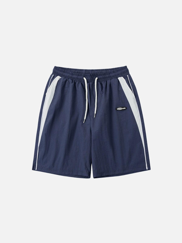 Navy blue color blocking shorts by TALISHKO, front view with white accent stripes.
