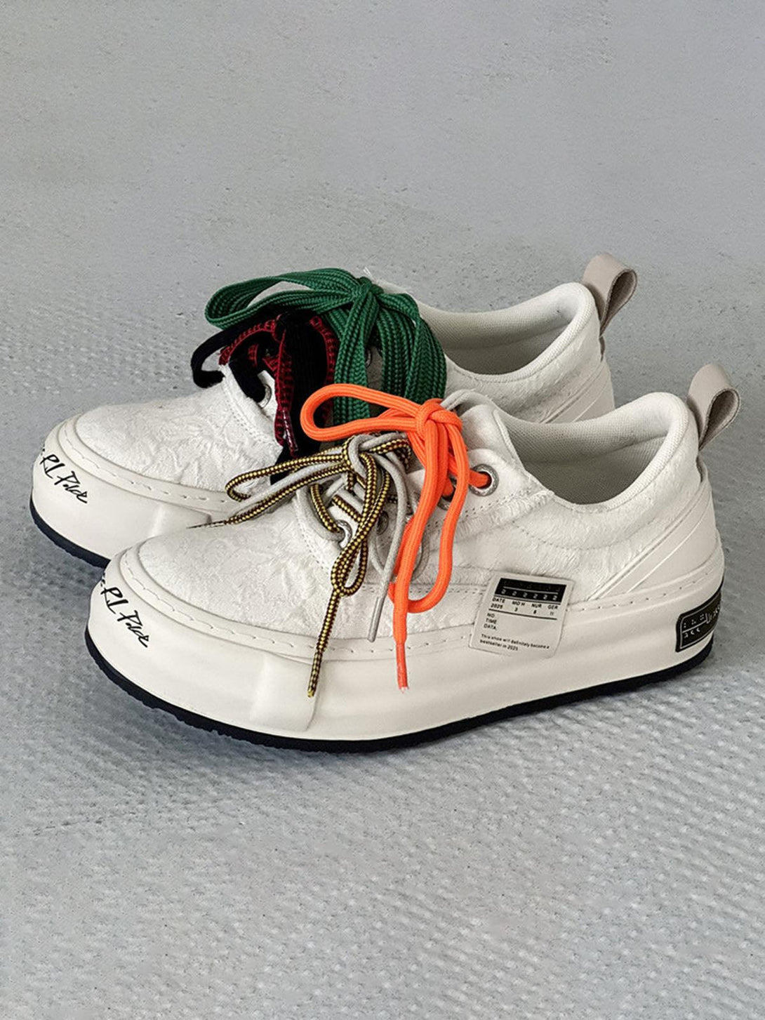 TALISHKO sneakers in off-white with vibrant laces offer a unique street-inspired look.