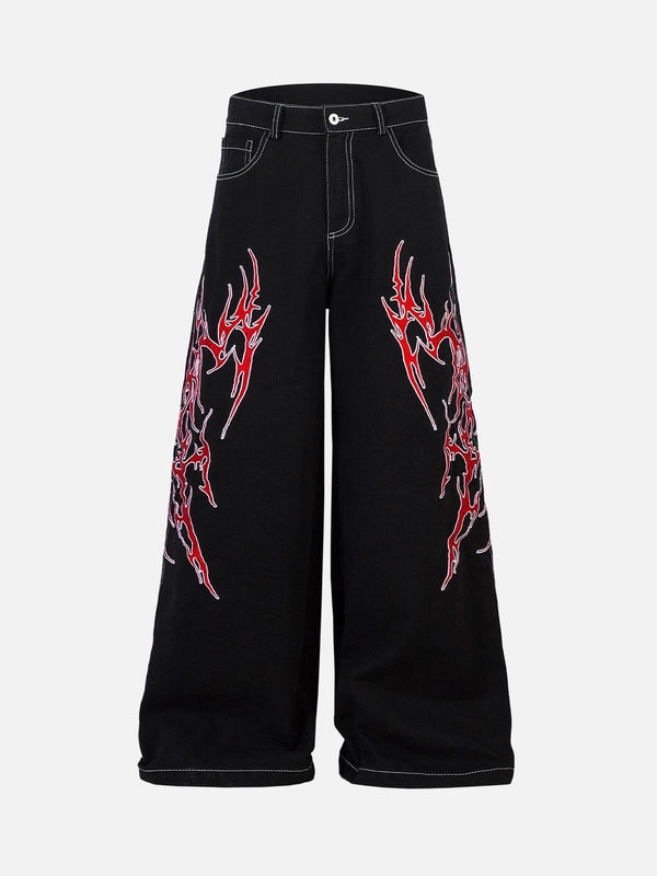Front view of black baggy jeans with red flame embroidery by TALISHKO, ideal for urban style.