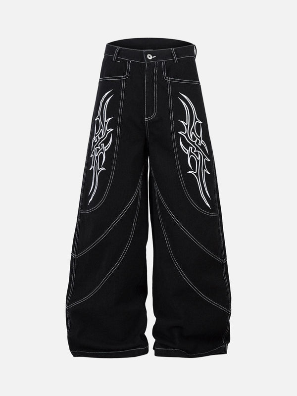 Front view of black baggy jeans with bold embroidery by TALISHKO, perfect for urban style.