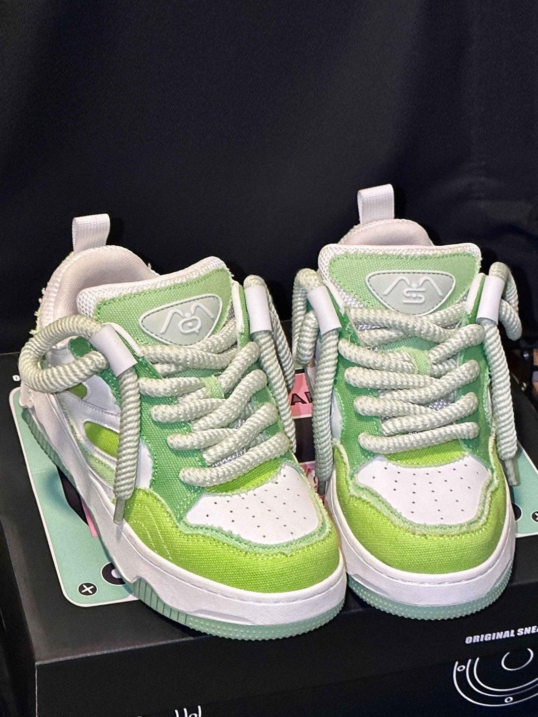 Green sneakers by TALISHKO with bold laces and thick soles, ideal for urban style enthusiasts.
