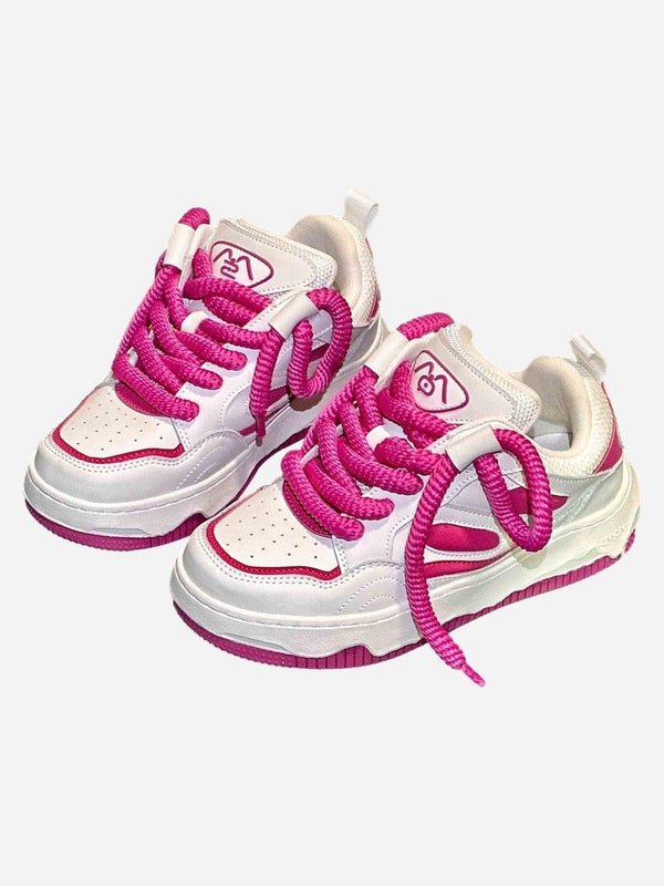 White and pink sneakers by TALISHKO with bold laces, perfect for a trendy streetwear look.