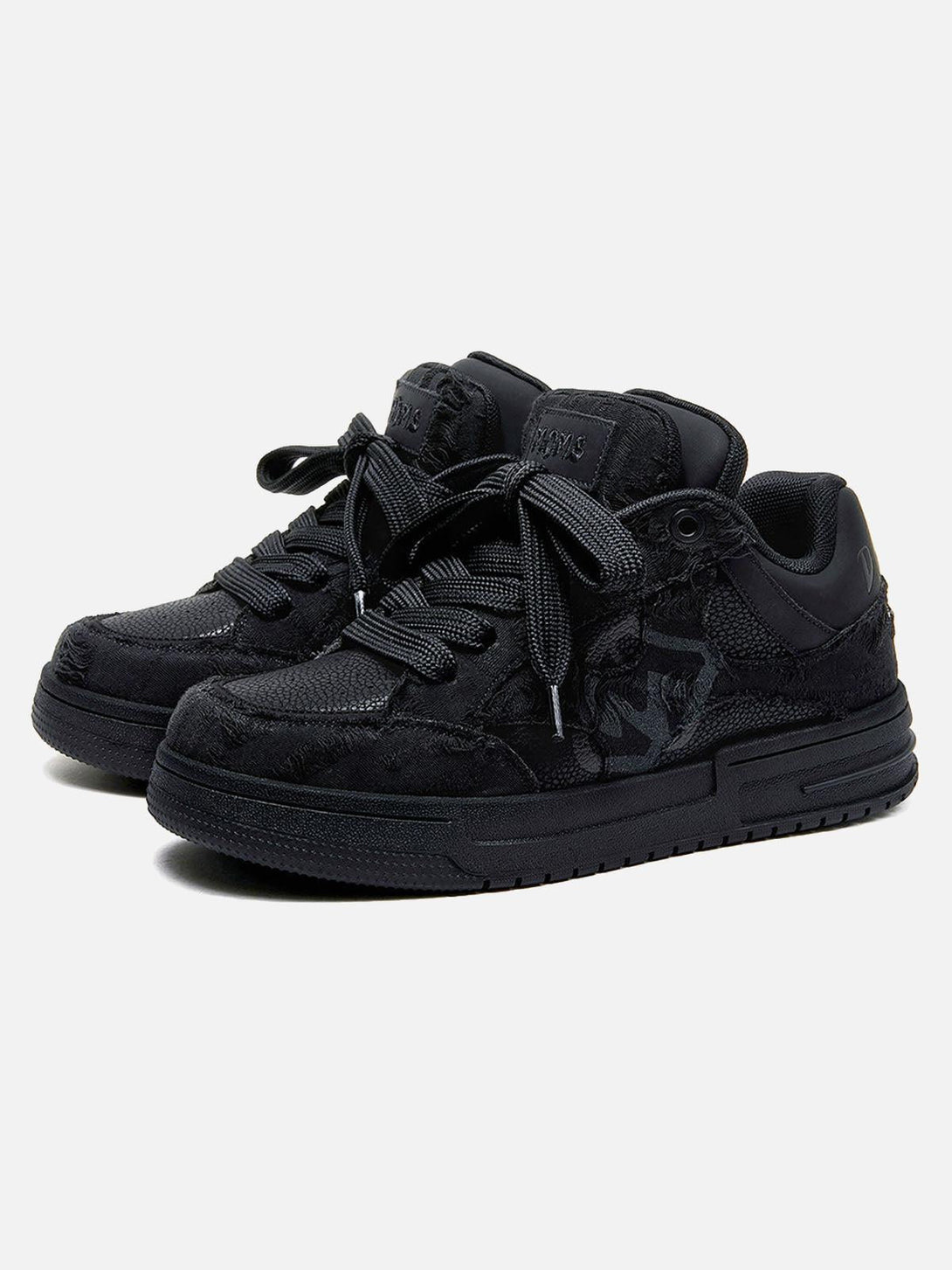 Black skate shoes with intricate textures, designed by TALISHKO, front view.