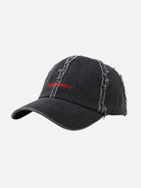 A black distressed denim baseball cap by TALISHKO, featuring rugged detailing for a stylish edge.