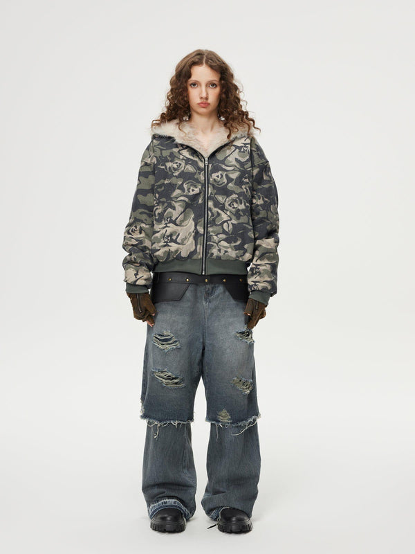 Model wears TALISHKO distressed baggy jeans with layered design, showcasing edgy street style.