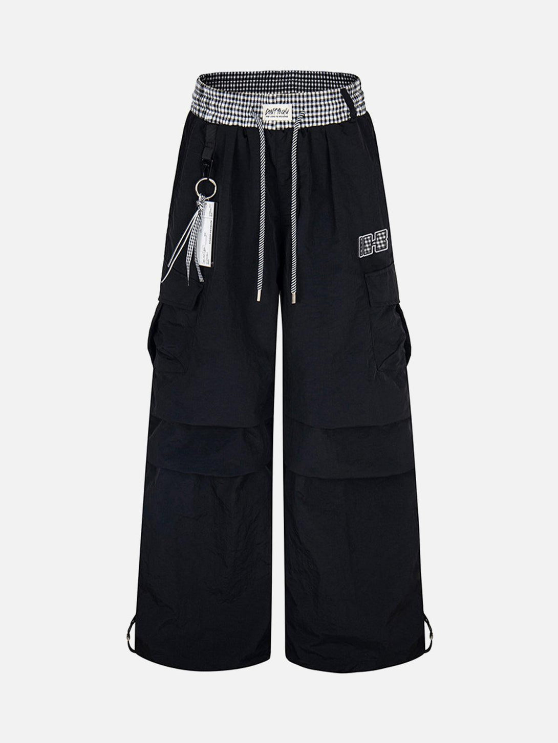 Front view of black baggy cargo pants with double waist drawstring by TALISHKO, perfect for edgy style.