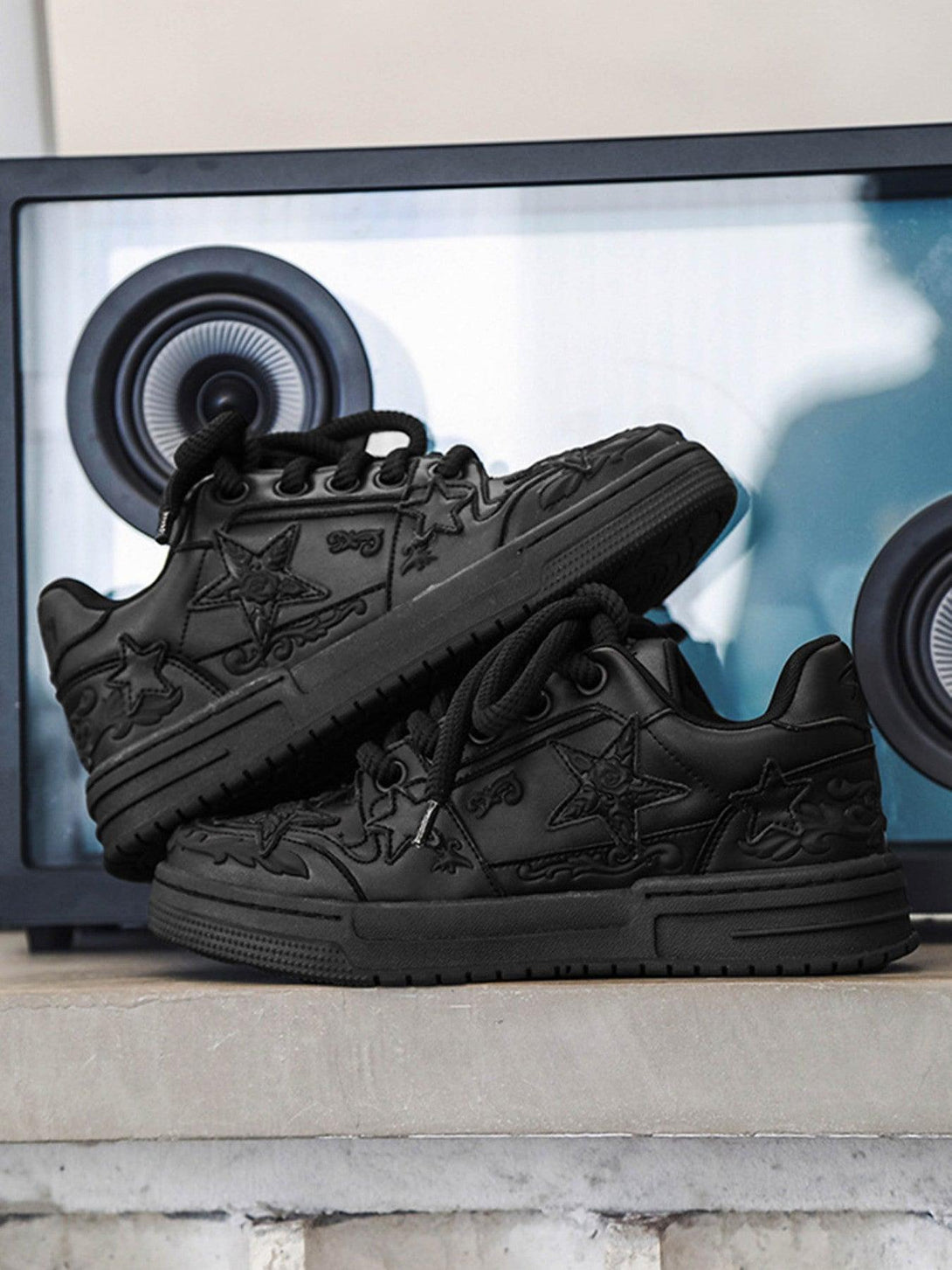 A front view of black embossed star casual board shoes by TALISHKO, perfect for urban style.