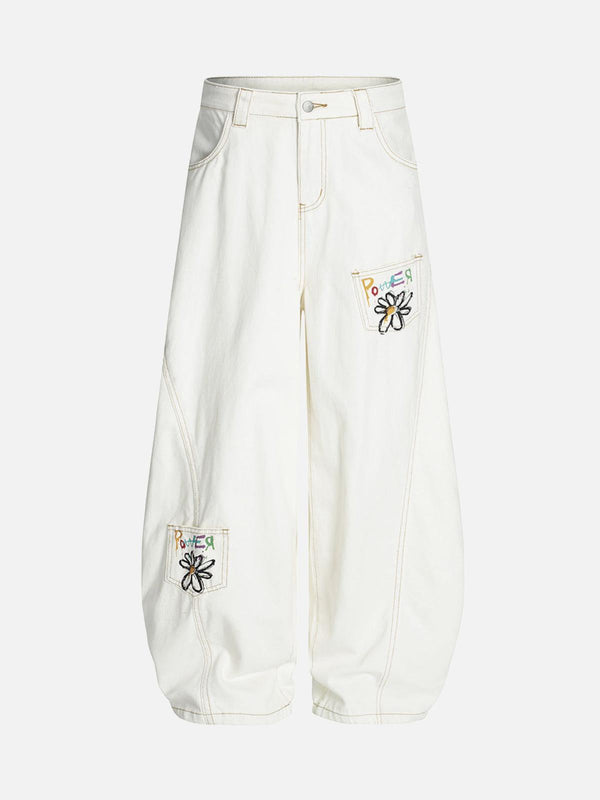 TALISHKO white barrel jeans with embroidered floral patches, front view highlighting style.