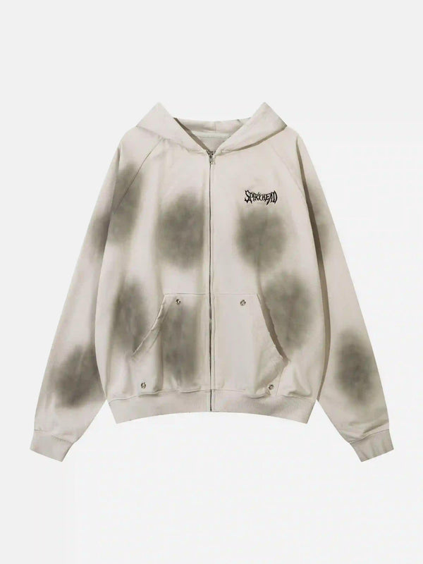 Front view of a beige zip-up hoodie by TALISHKO, featuring unique embroidery and spots.