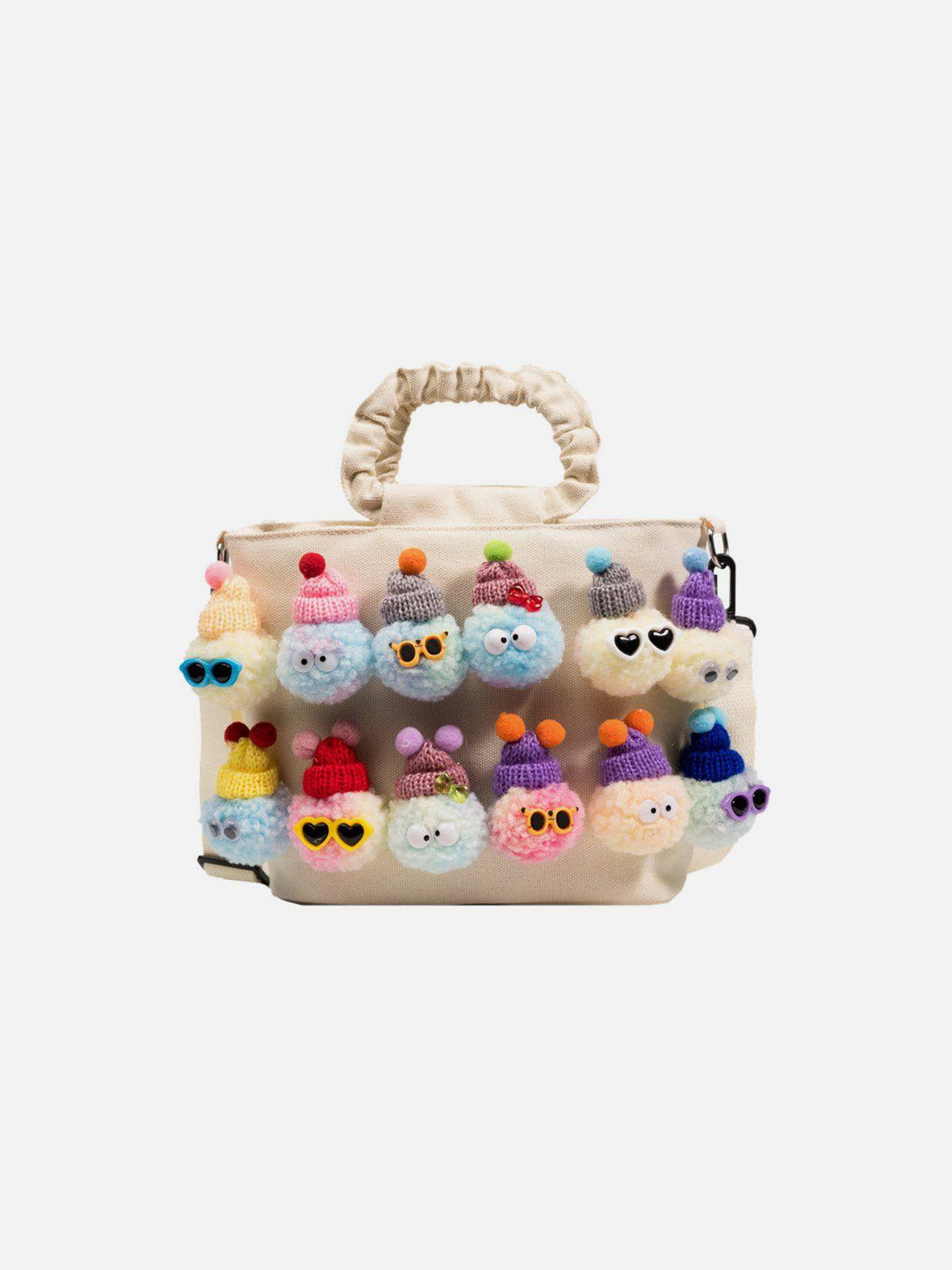 Front view of TALISHKO's apricot canvas bag adorned with playful pom-pom characters.