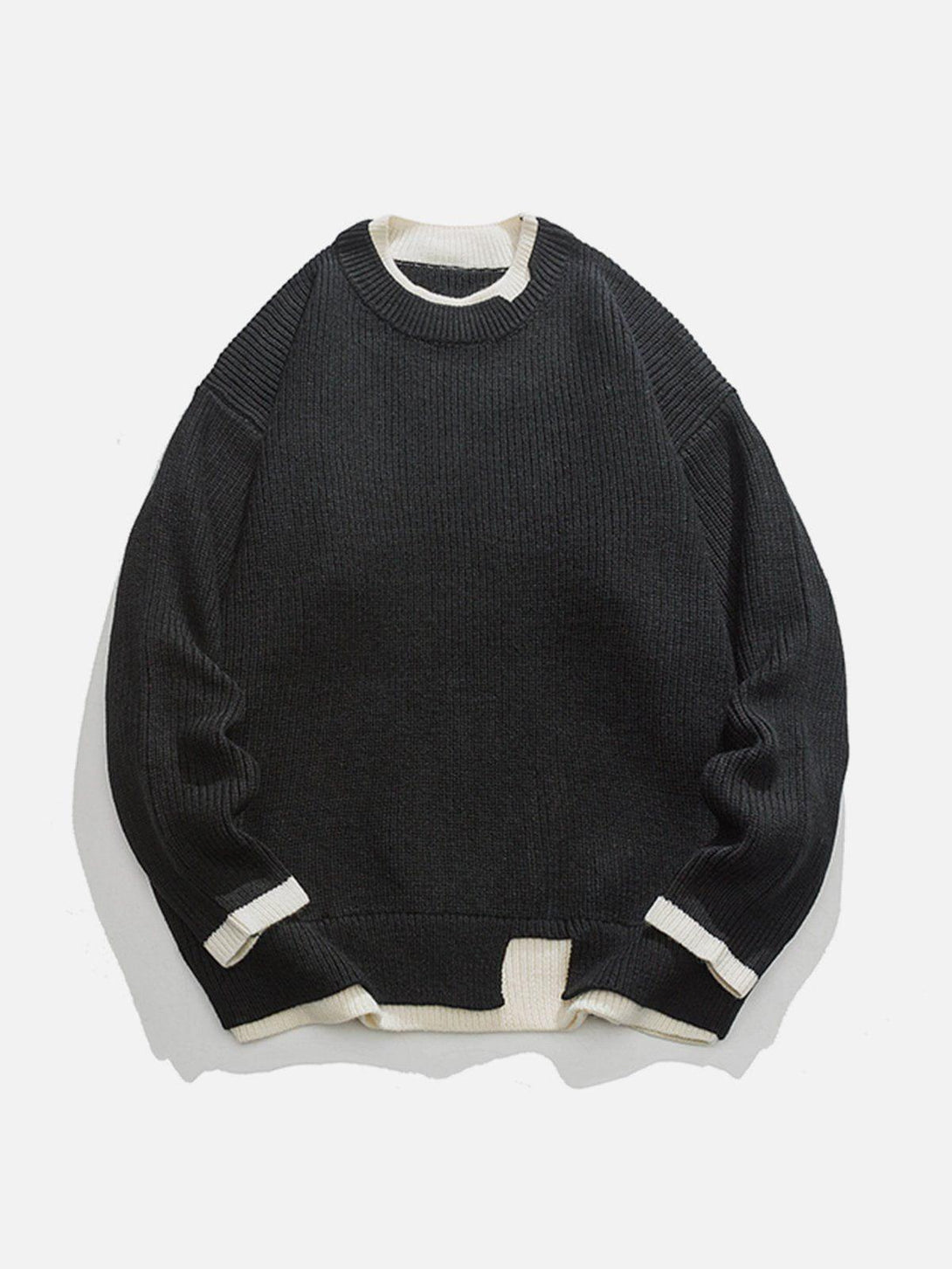 Front view of TALISHKO's black patchwork knit sweater with contrasting white accents.