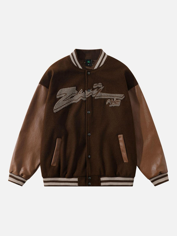 Front view of a brown baseball jacket with flocking embroidery by TALISHKO, featuring leather sleeves.