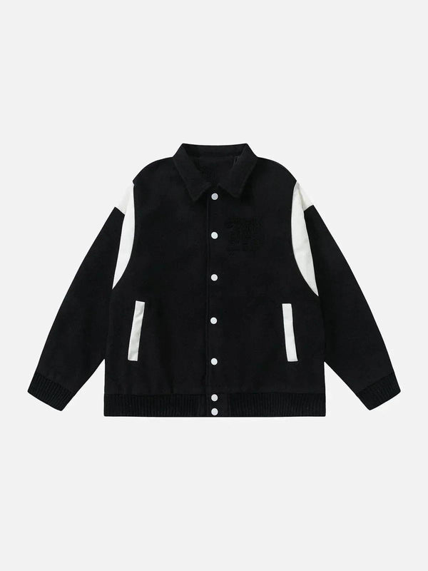 Front view of a black varsity jacket with white accents by TALISHKO, ideal for urban style.