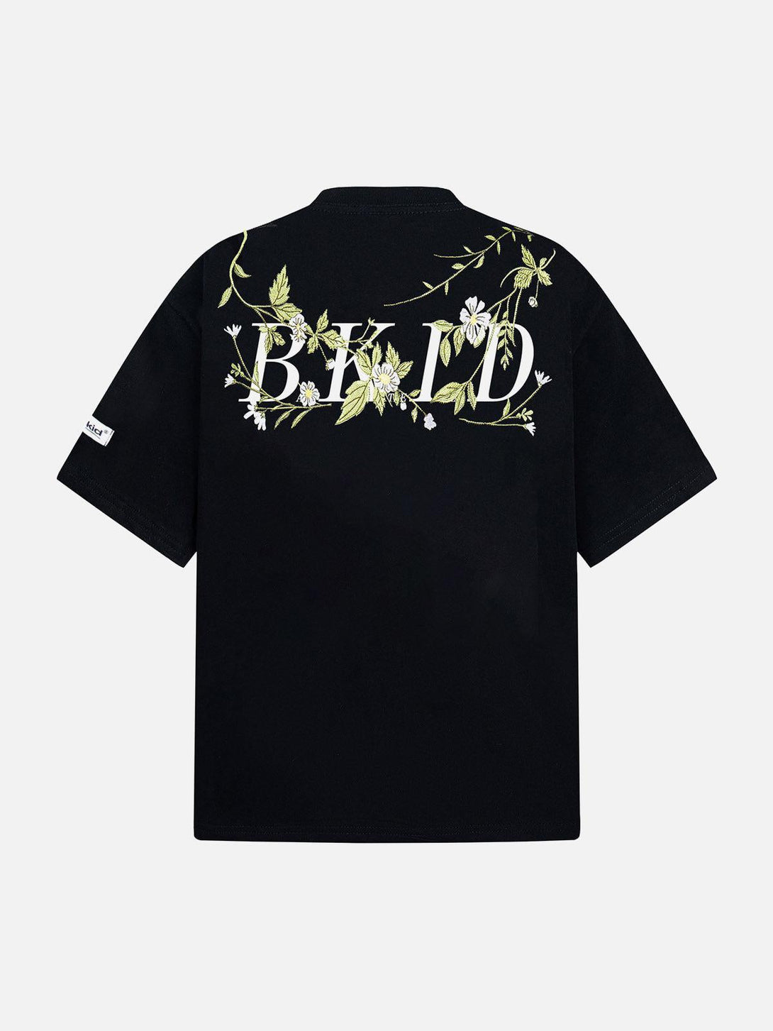 Back view of a black oversized t-shirt with floral embroidery, designed by TALISHKO.