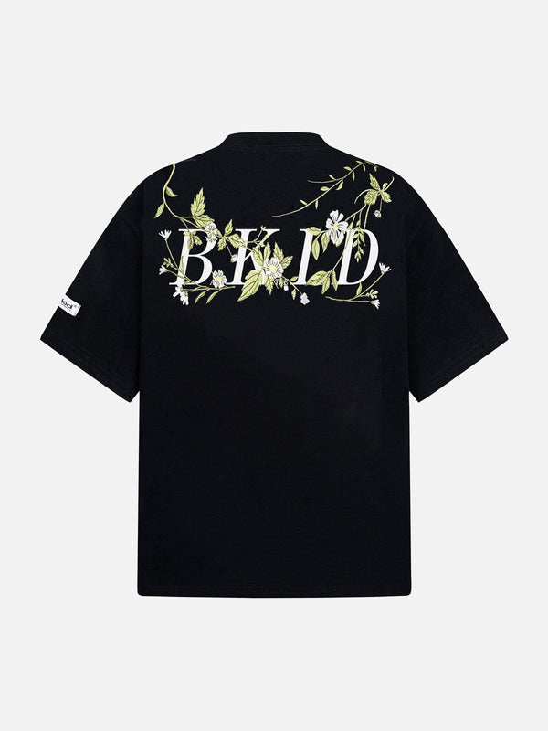 Back view of a black oversized t-shirt with floral embroidery, designed by TALISHKO.