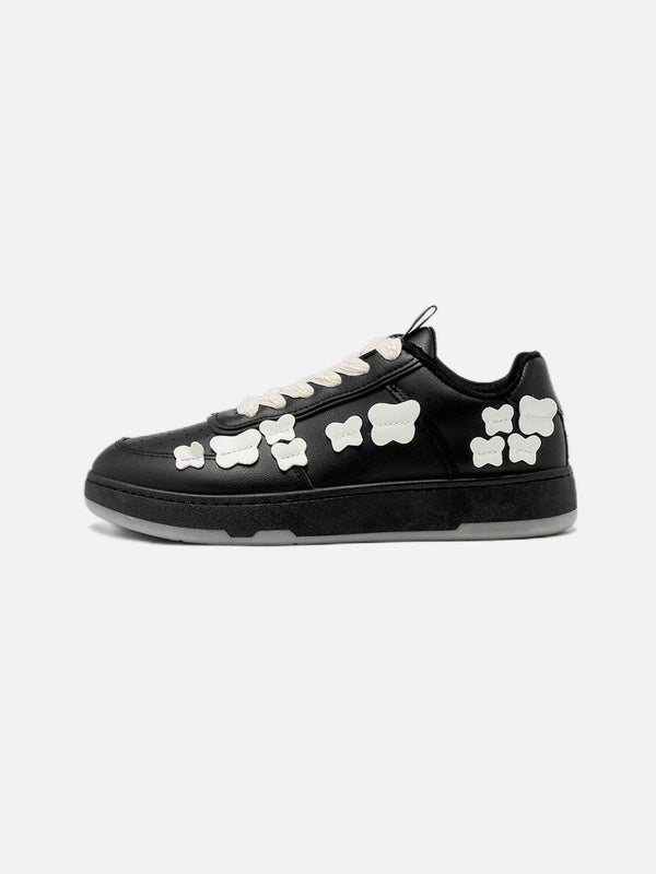 Side view of black skate shoes with white butterfly details by TALISHKO, perfect for urban style.