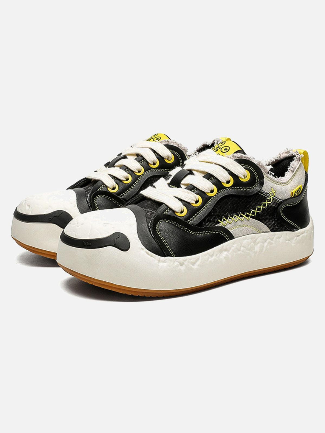 TALISHKO black leather spliced sneakers with a playful design, featuring a unique front view.