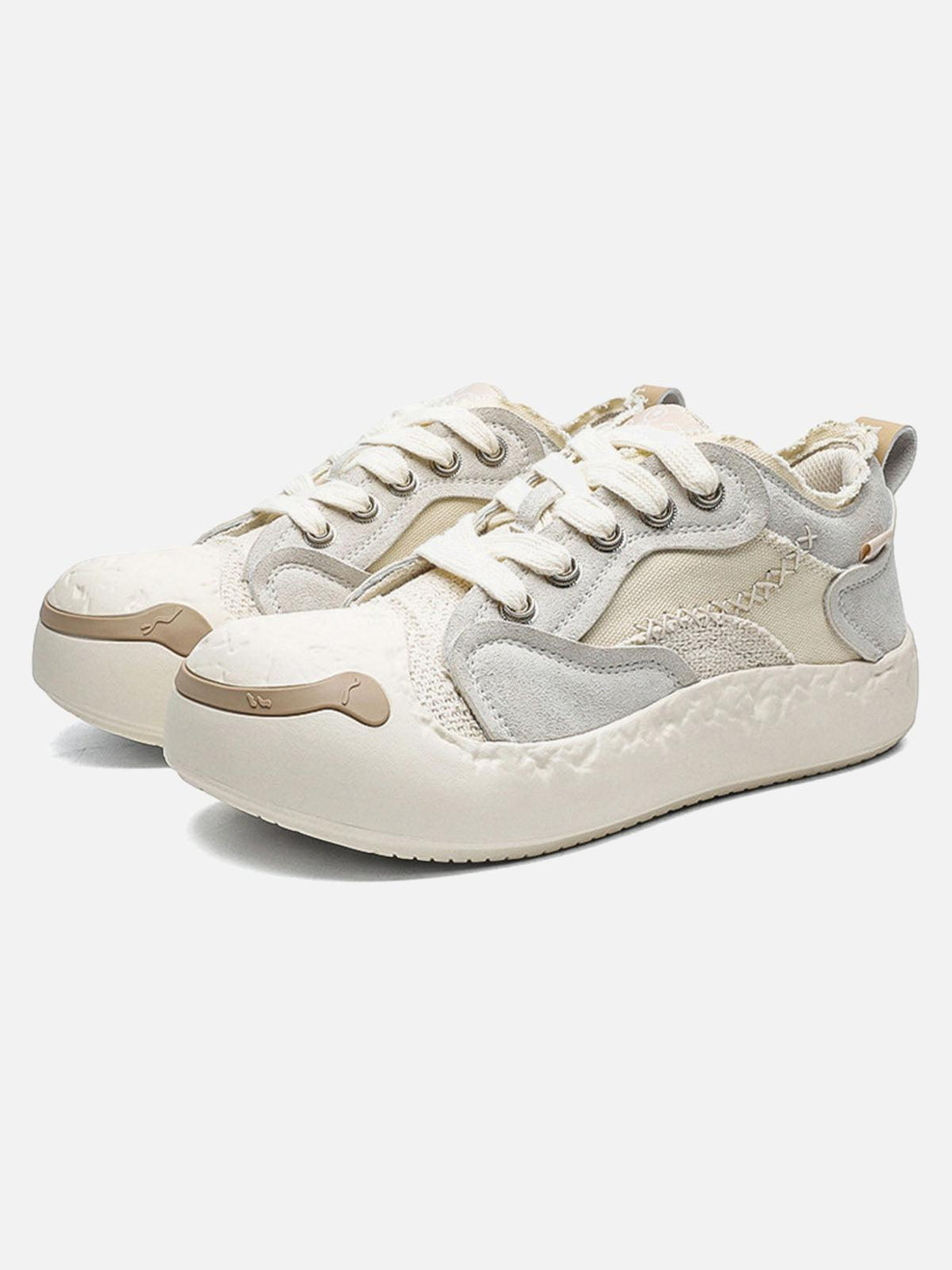 Front view of TALISHKO white leather spliced sneakers with playful design details.