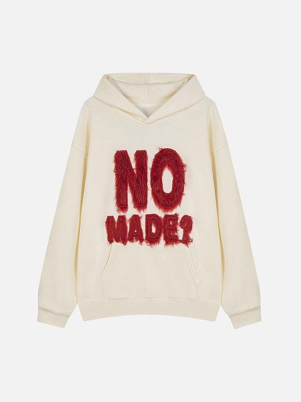 Front view of apricot hoodie with fur patchwork design by TALISHKO, showcasing bold embroidery.