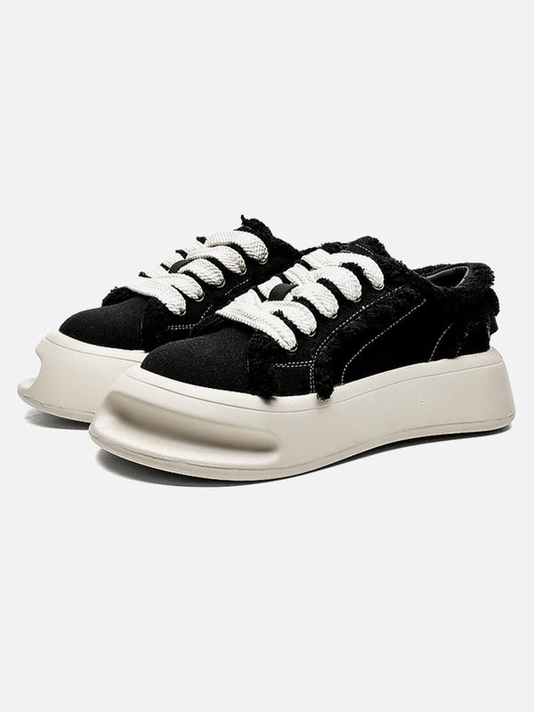 Front view of black fuzzy trim chunk shoes by TALISHKO, featuring bold white laces.