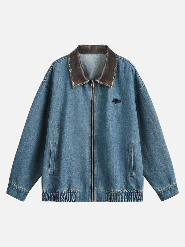 Front view of a blue denim work jacket by TALISHKO, featuring a contrasting brown collar.