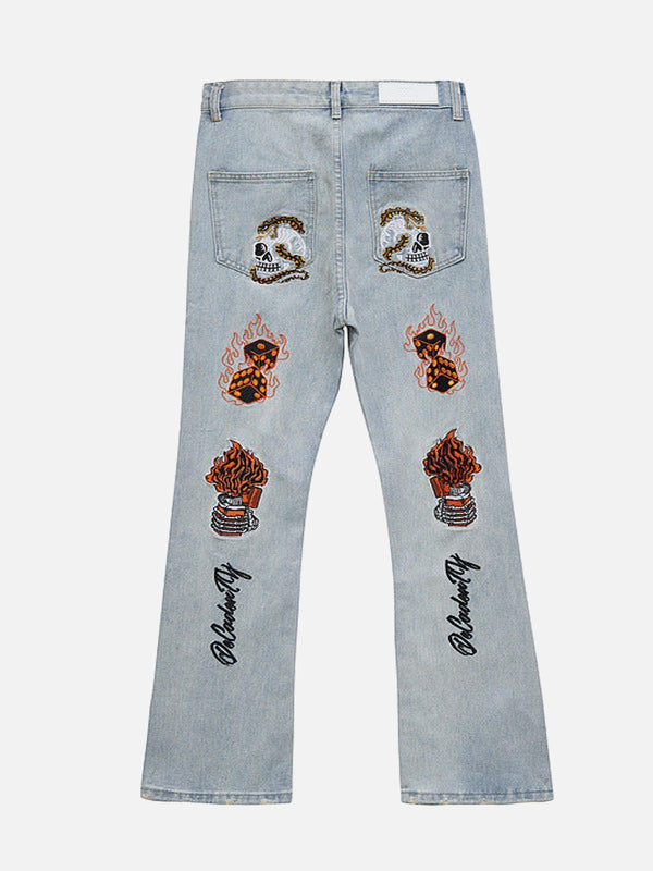 Back view of blue retro embroidered jeans by TALISHKO, featuring skull and flame designs.