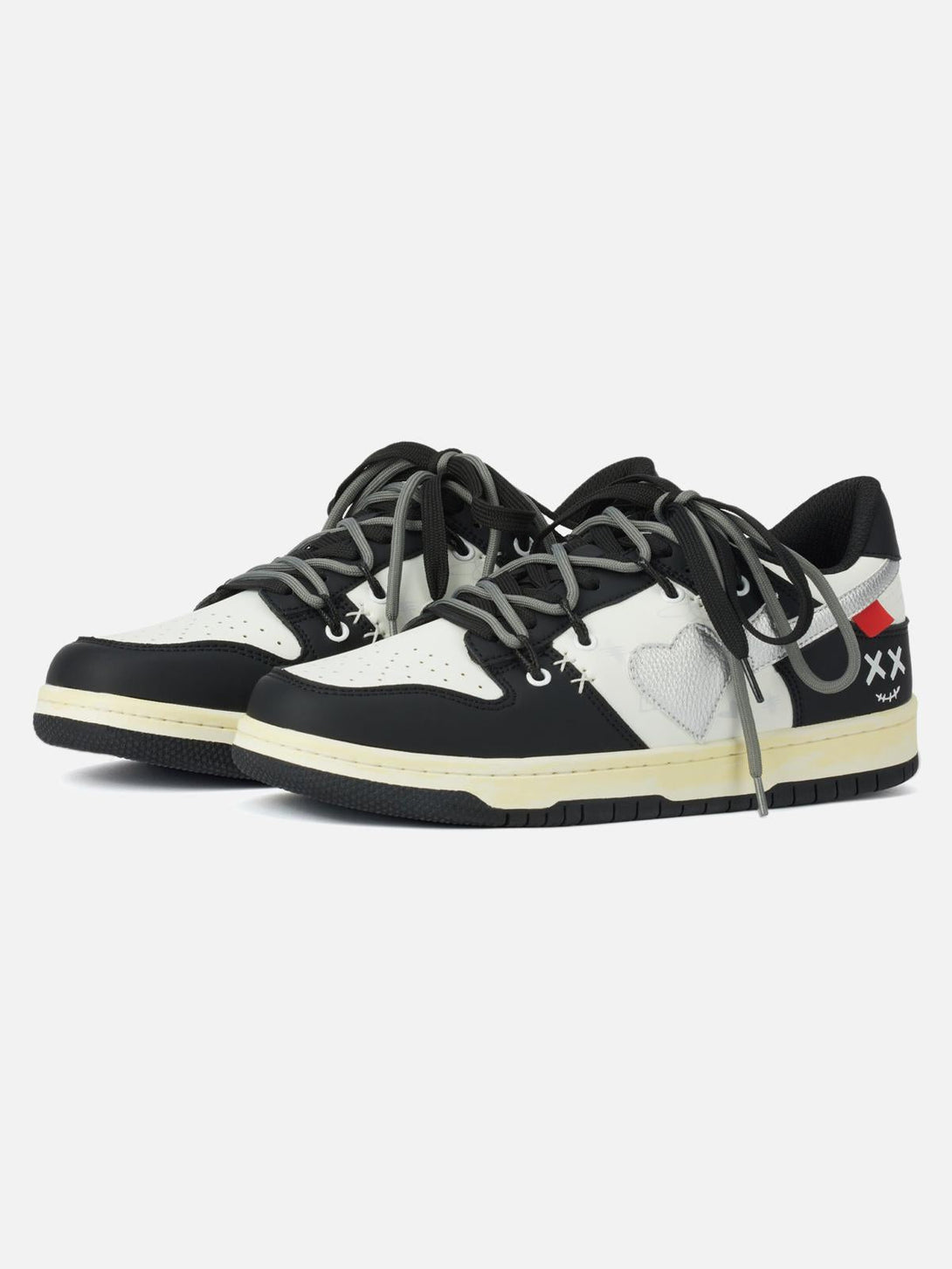 Front view of TALISHKO high street black sneakers, featuring heart and cross designs.