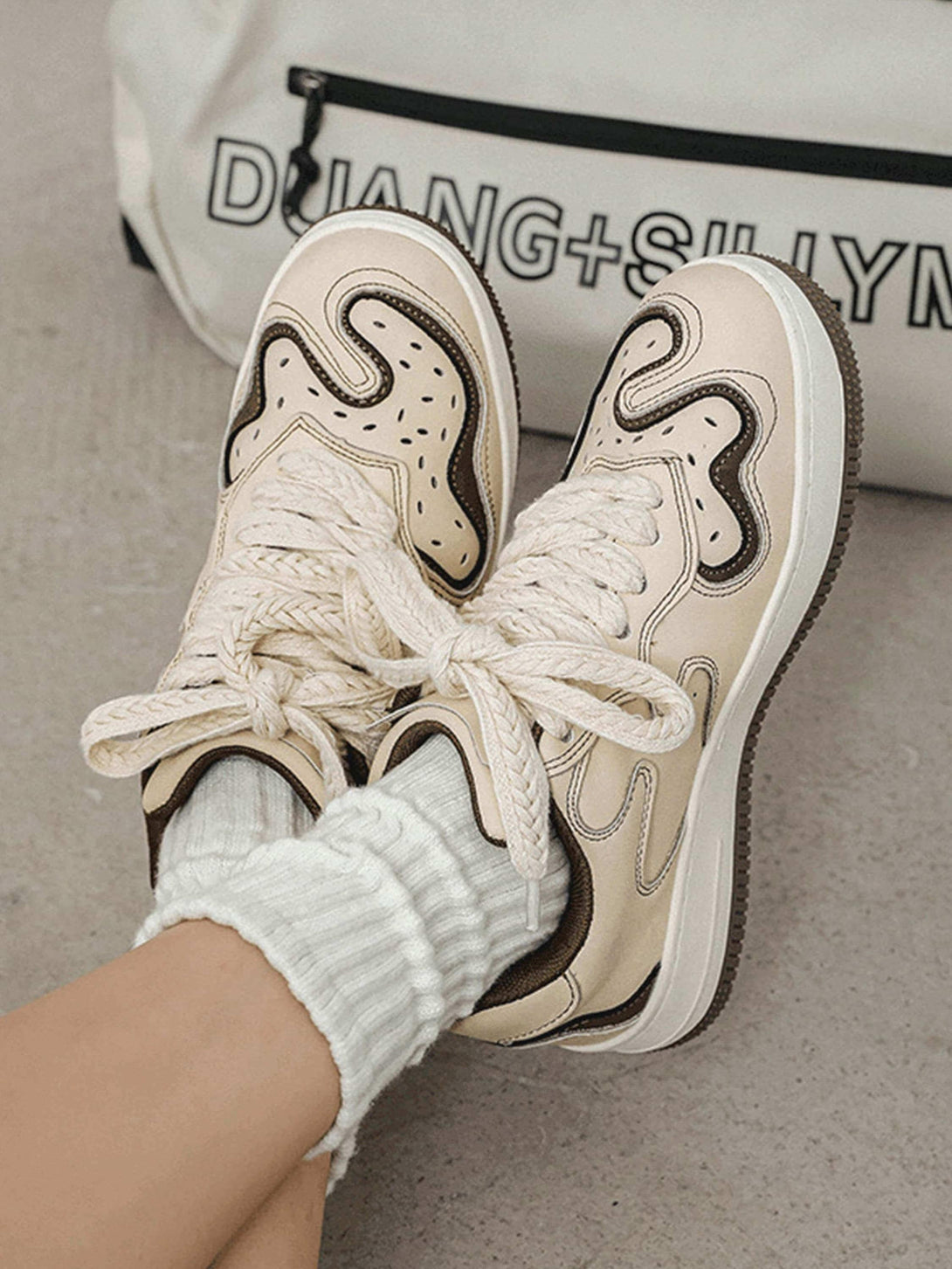 TALISHKO beige skateboard shoes with unique design and thick laces, capturing urban style.