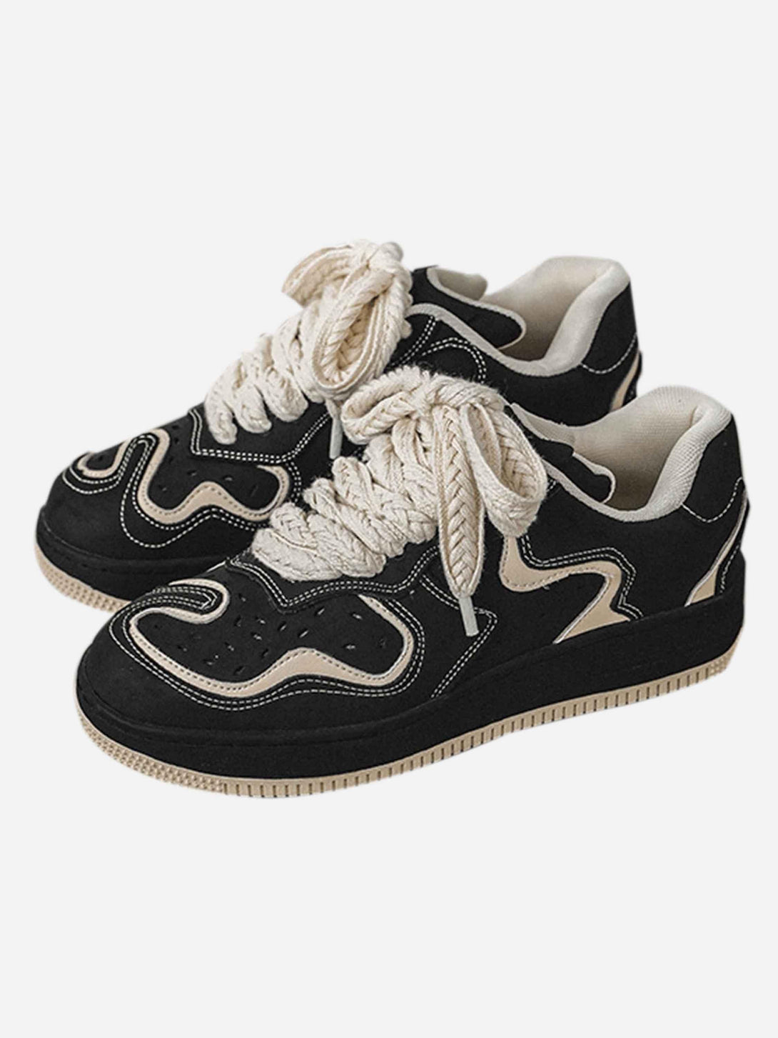Black skateboard shoes by TALISHKO featuring bold design and thick laces, styled for streetwear.