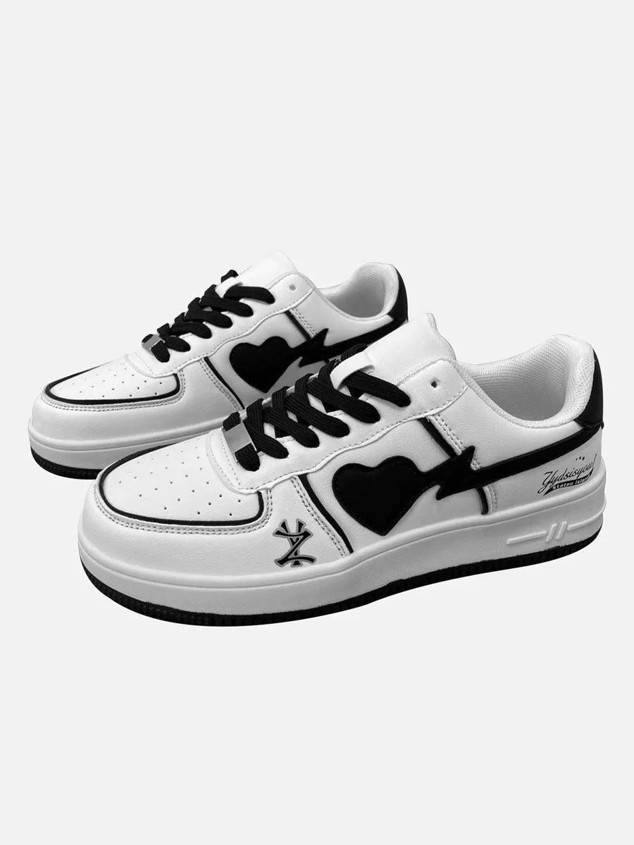 White skate sneakers by TALISHKO with bold heart design, featuring black accents and laces.