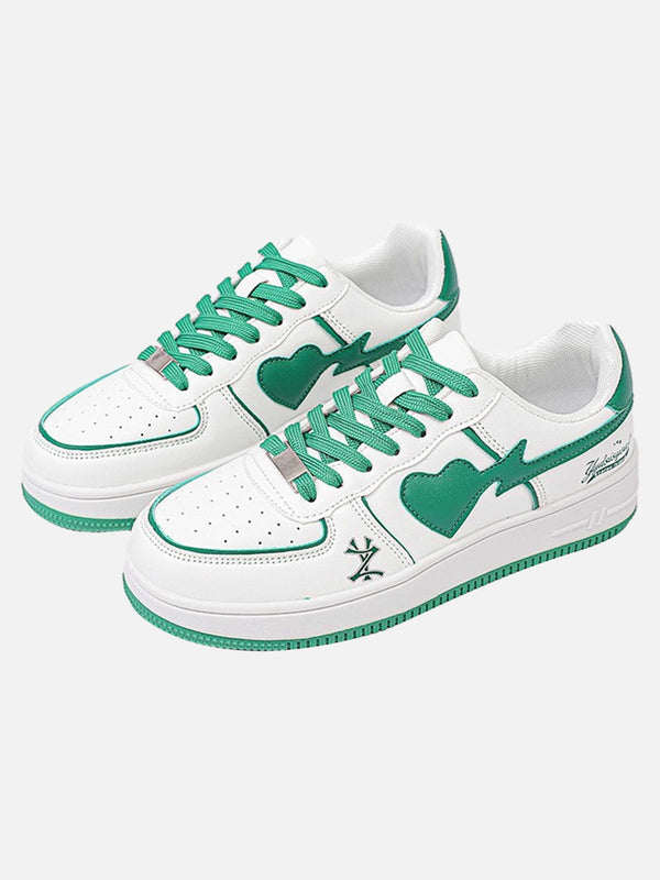 Stylish white skate sneakers with green accents by TALISHKO, showcasing a bold heart design.