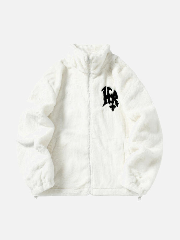 Front view of a white fur jacket by TALISHKO, featuring bold lettering and a stand collar.