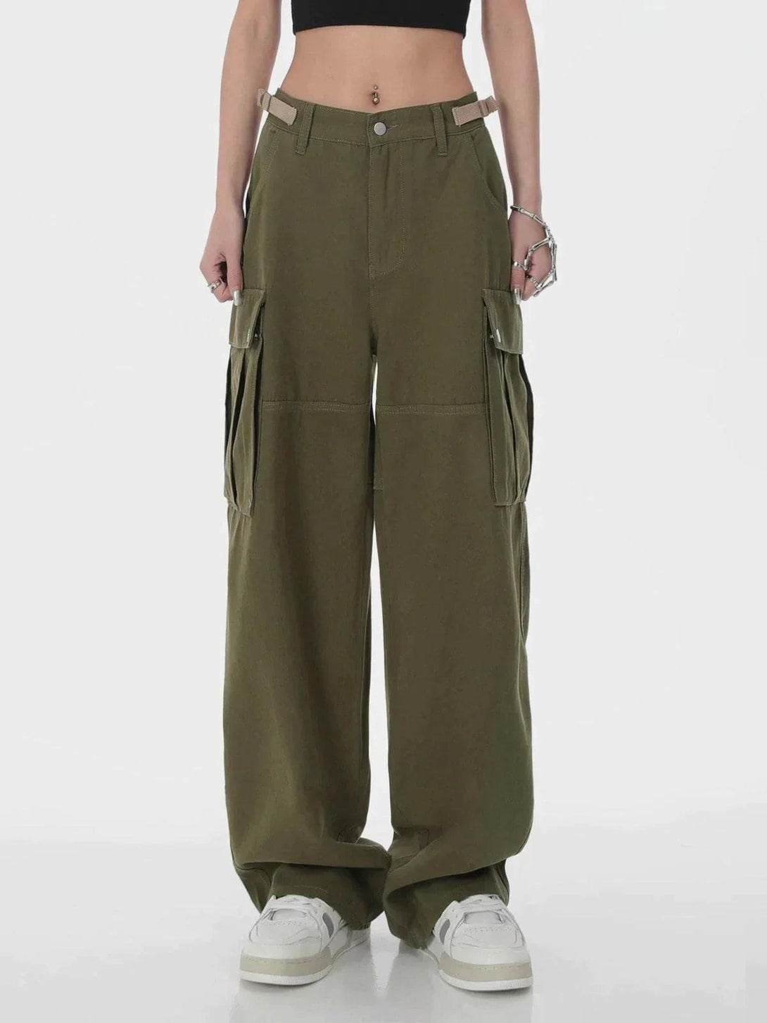 Model in green TALISHKO cargo pants, paired with white sneakers and a black crop top.