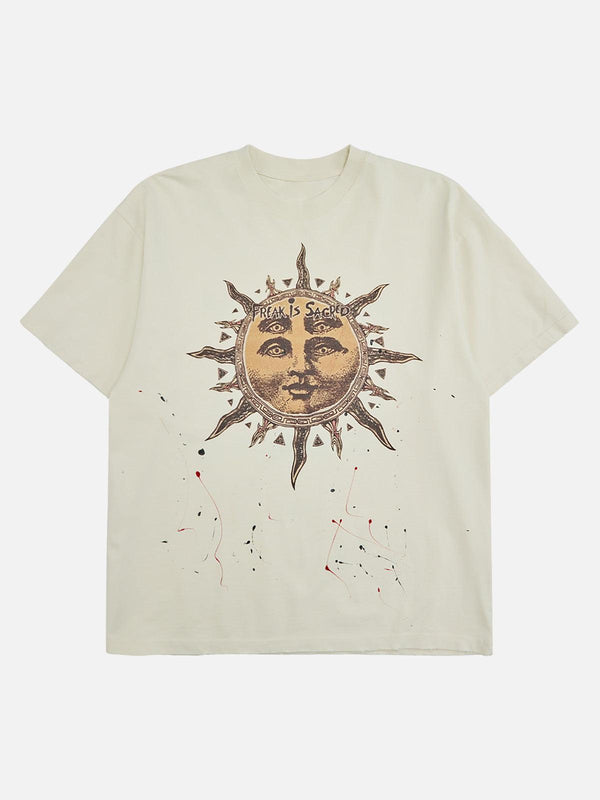 Front view of an apricot T-shirt by TALISHKO featuring an ink-splashed sun god design.