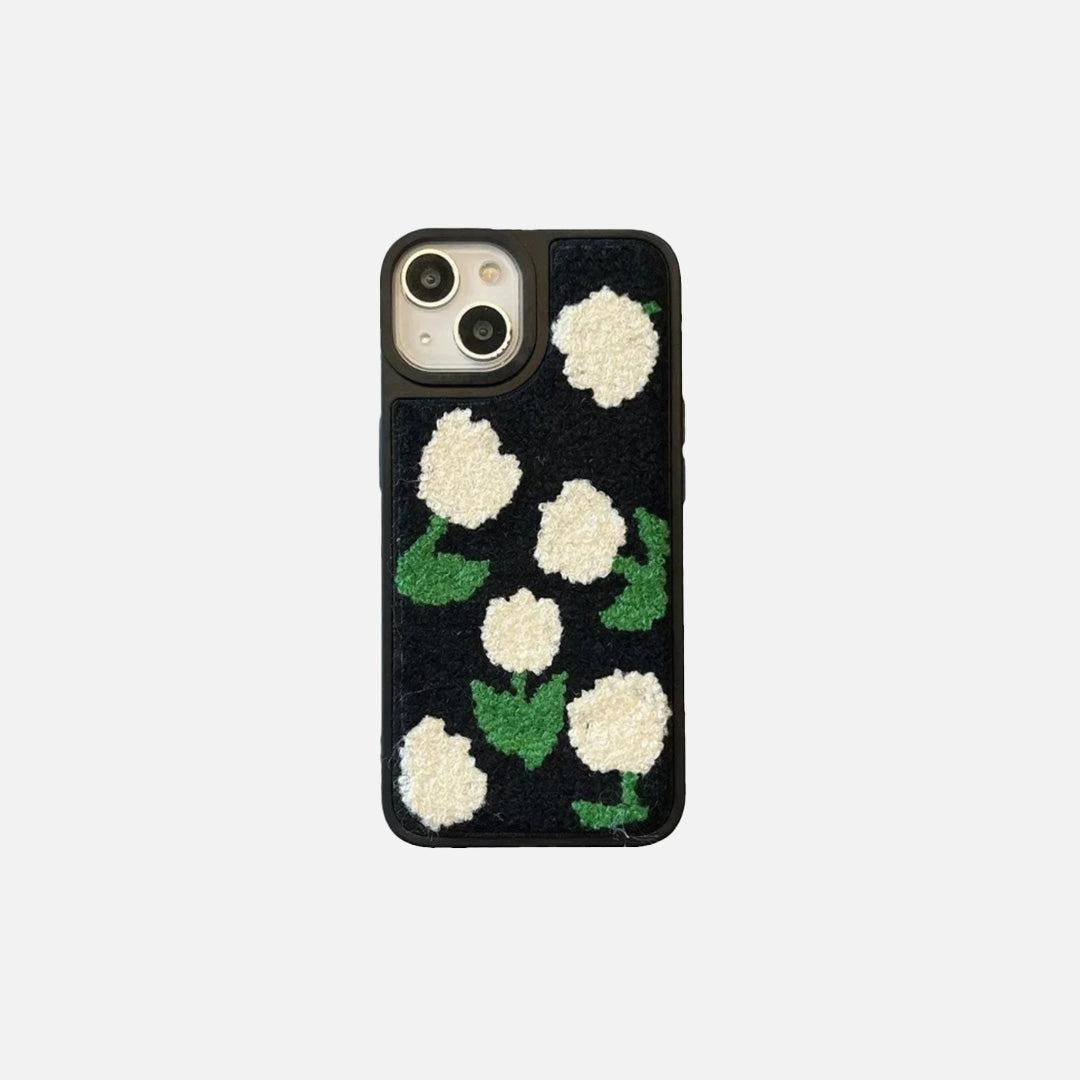 Front view of a TALISHKO iPhone case with a charming plush floral design in green and white.