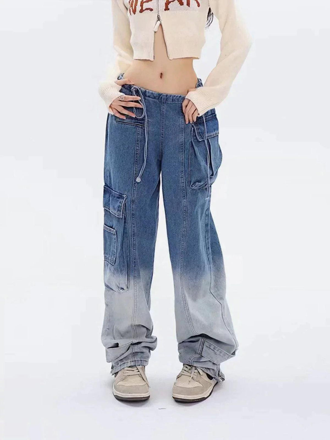 Model wearing blue gradient jeans with large pockets, styled by TALISHKO for urban appeal.