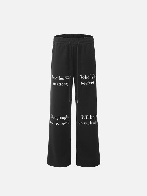 Black lettering print sweatpants by TALISHKO, front view highlighting casual street style.
