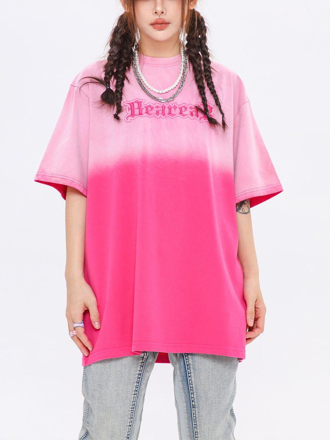 Front view of a pink vintage tee by TALISHKO featuring a bold letters graphic design.