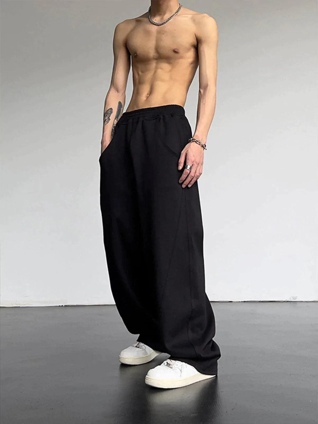Model in black loose high waist pants by TALISHKO, highlighting a relaxed, urban vibe.