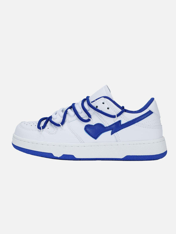 Side view of TALISHKO white skate shoes with blue accents and heart detail, perfect for casual style.
